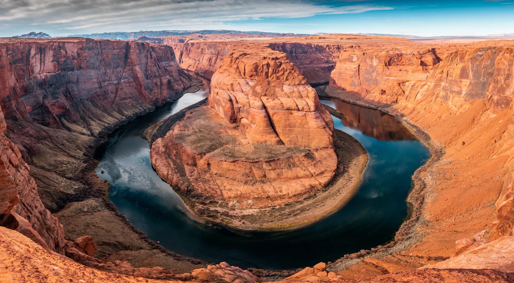 A horseshoe-shaped river bend encircled by canyon walls