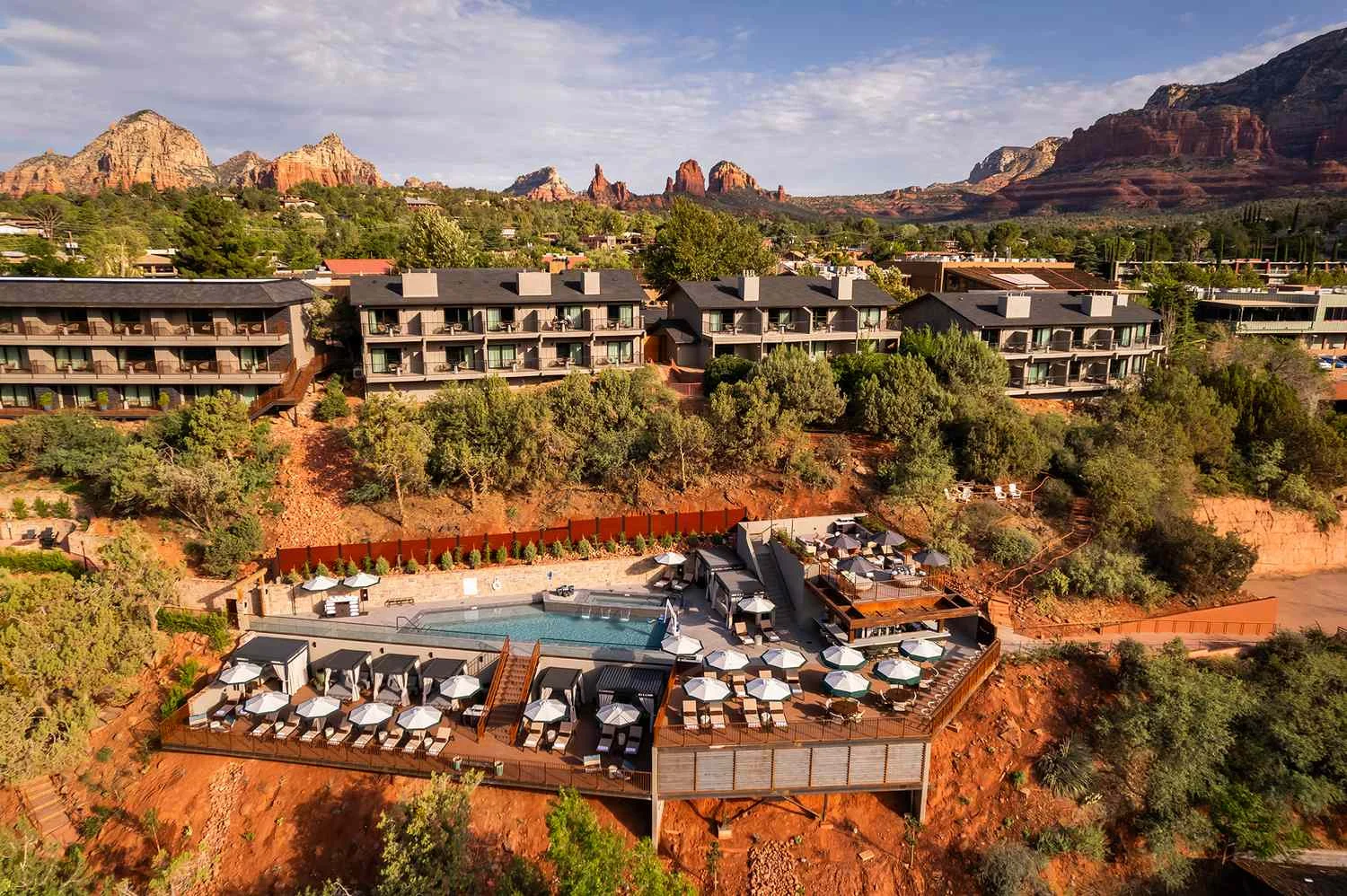 Lodging and a pool terrace set among red-rock hills