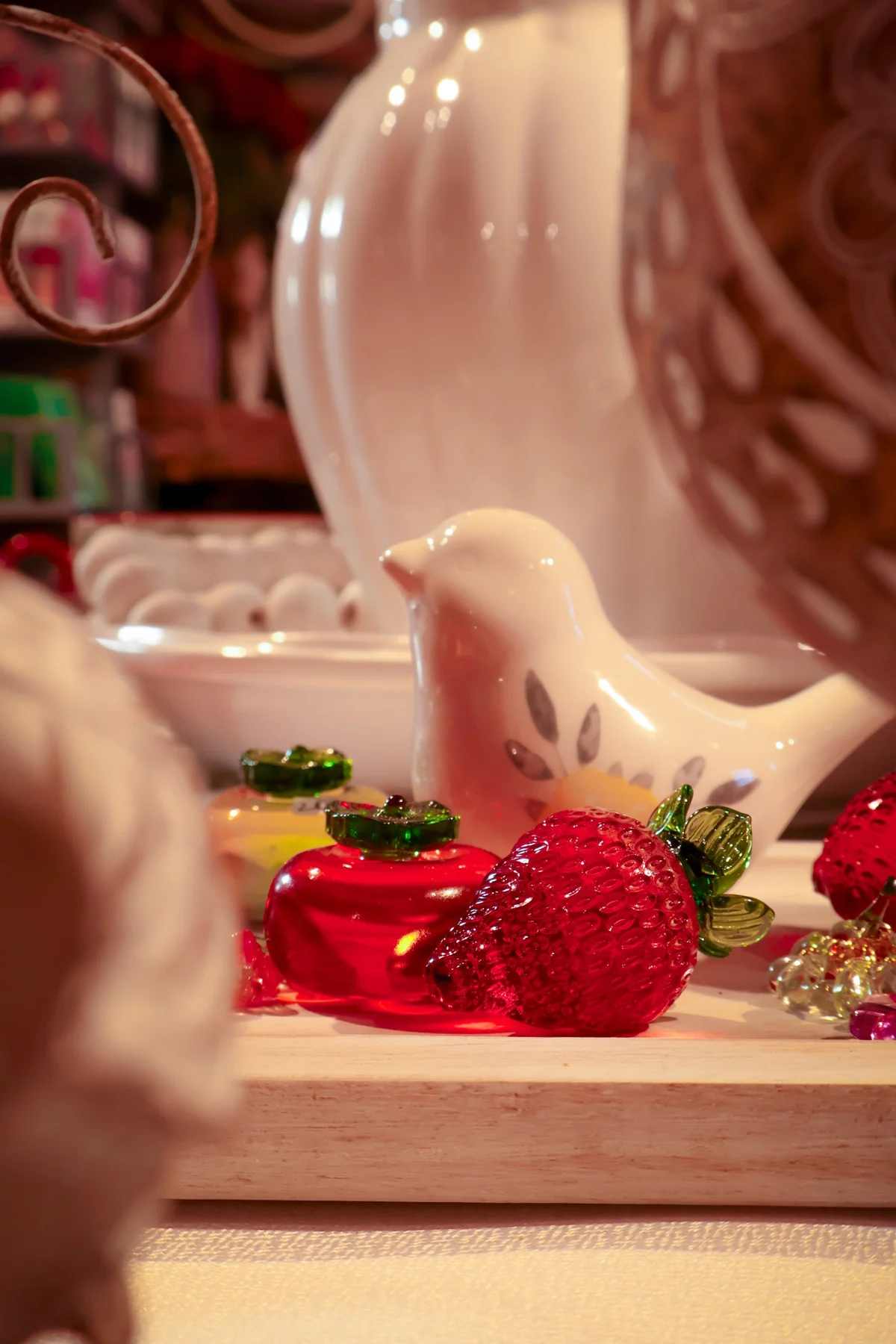 Decorative ceramic birds and small red gifts on display