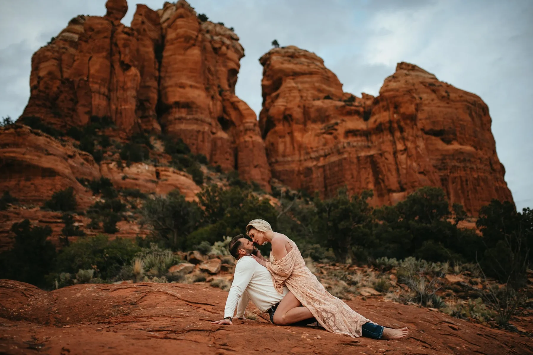 A couple embracing on a red-rock overlook