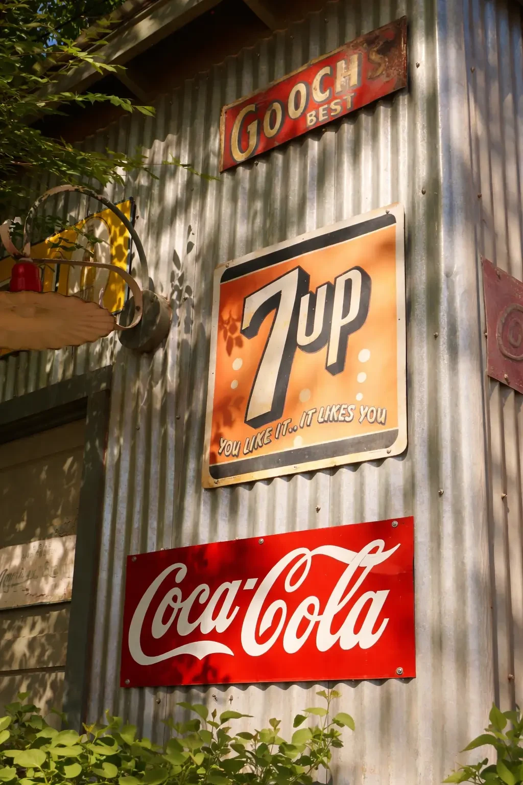 Vintage 7UP and Coca-Cola signs on a wooden wall